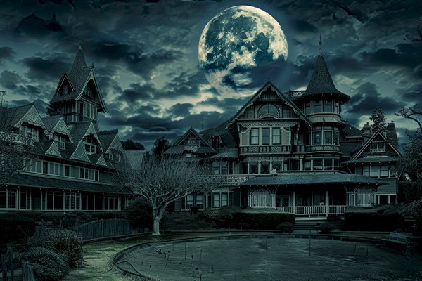 A large, dark mansion with a full moon and cloudy night sky in the background, creating an eerie and mysterious atmosphere, ending the sentence.